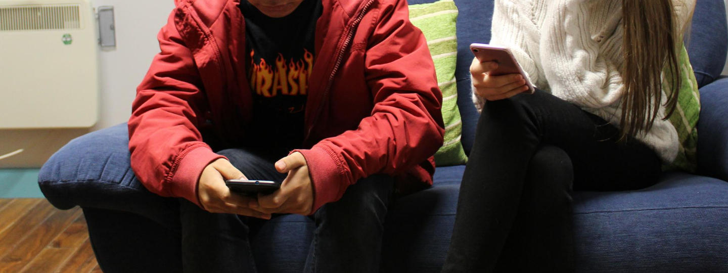 Close up of a woman using a phone on a computer