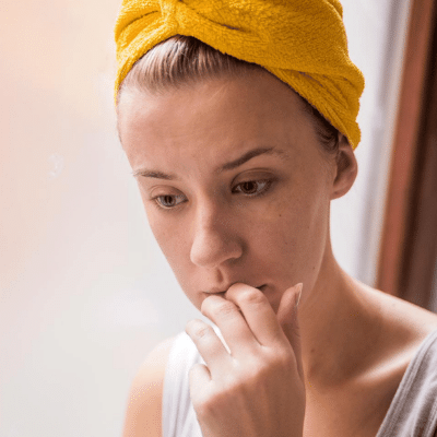 young woman biting her nails