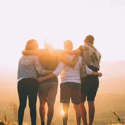 Picture of a group of friends with arms around each others shoulders