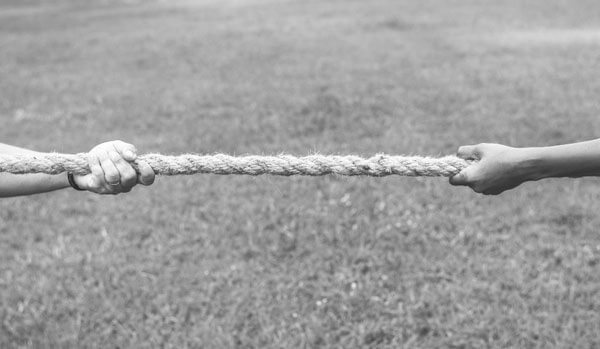 Hands pulling on either end of a rope