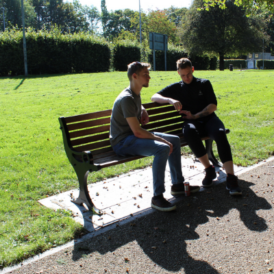 Two young men sitting on a bench