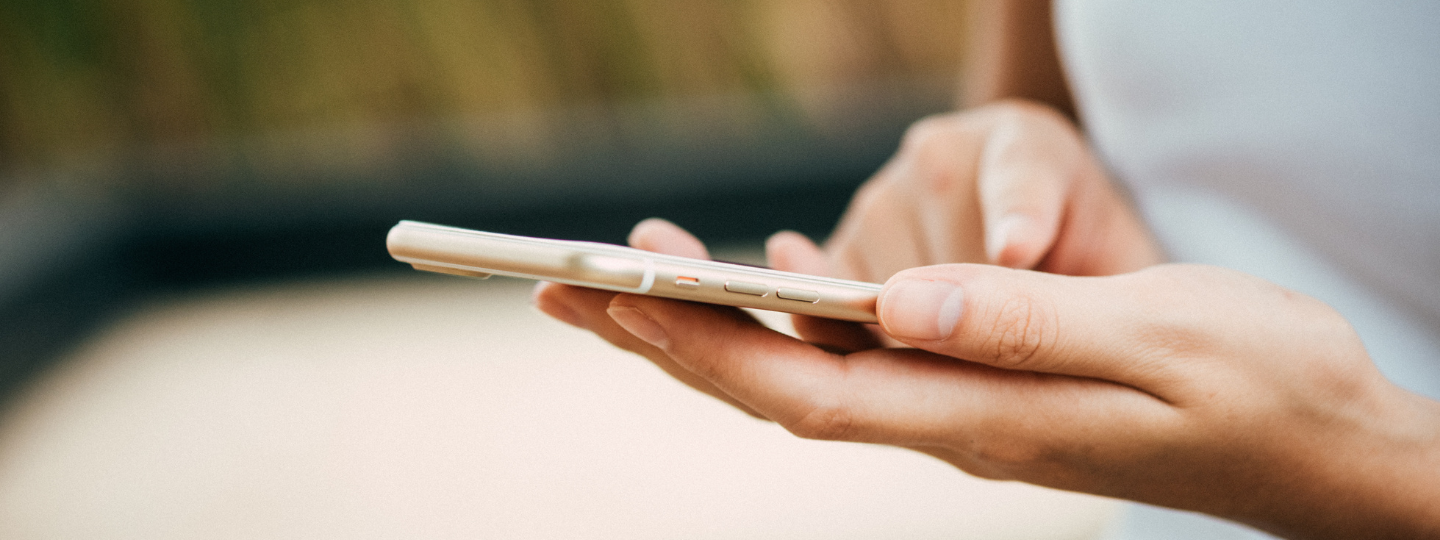 Close up of a woman's hand making a search on her phone