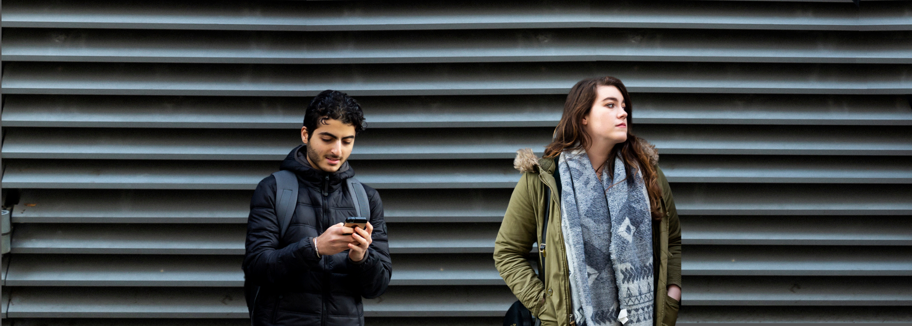 Two young people standing apart