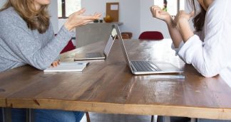 Banner image of twp staff facing each other over laptops