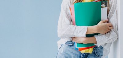 Banner image of a girl holding folders