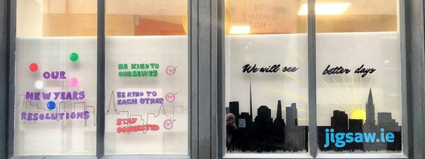 Banner image of a window display sharing positive messages for February