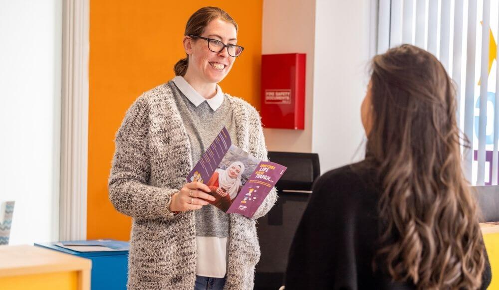 Woman greeting a young woman in a Jigsaw branch