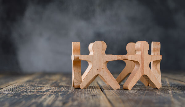 Circle of wooden figures on a table top