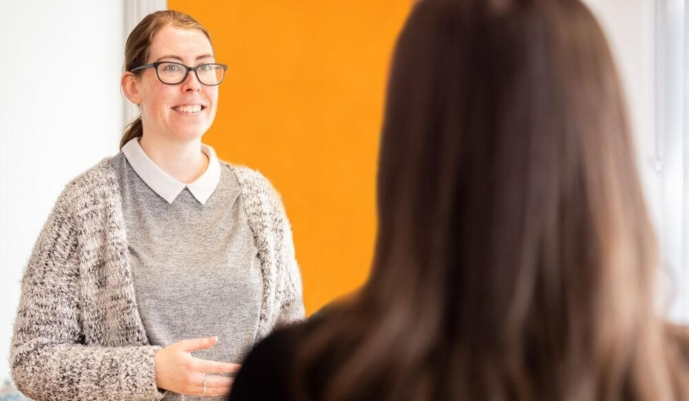 Woman meeting another woman in a reception