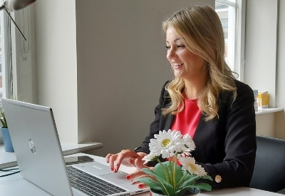 Clinical Online Service Manager, Mary Clare sitting at her test typing on her laptop